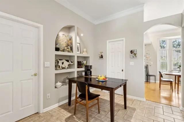 a view of a room that has a table and chairs in it