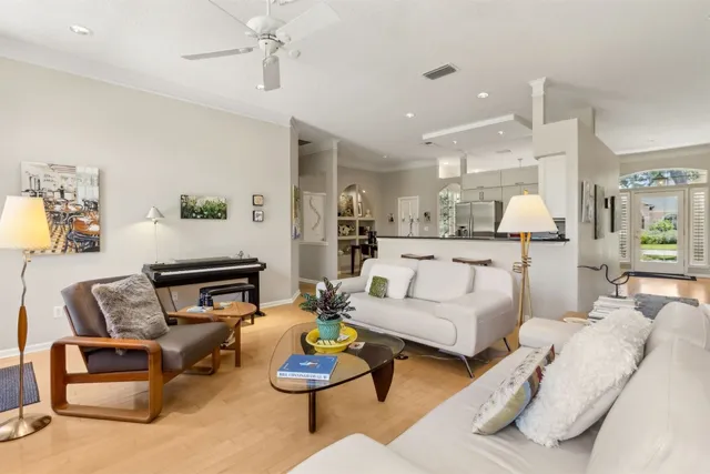 a living room with furniture and kitchen view