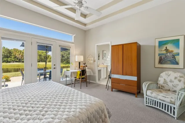 a bedroom with furniture and a large window