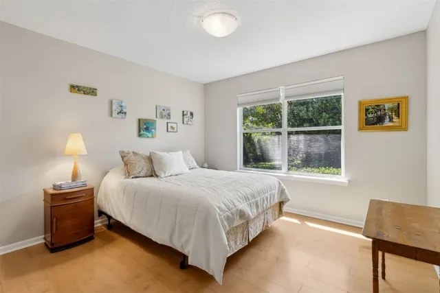 a bedroom with a bed and a window