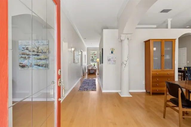 a view of a hallway with furniture and floor to ceiling window