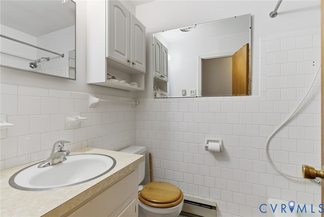 9093 Rutland Road Mechanicsville, VA 23116 - Photo 11 of 36 Full bathroom featuring tile walls, vanity, basebo