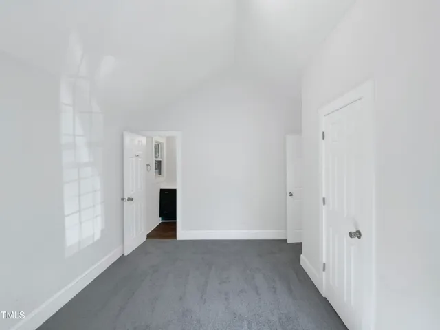 a view of a hallway with wooden shelves