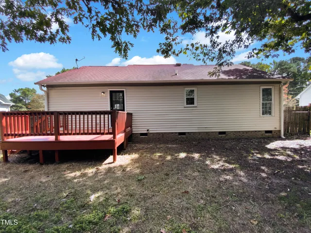 a view of a house with a yard and furniture