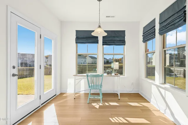 a view of wooden floor and a chandelier in a room