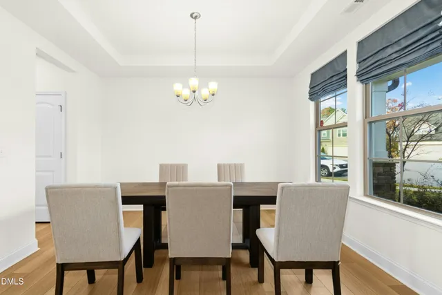 a view of a dining room with furniture wooden floor and a chandelier
