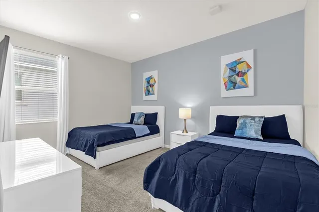 a bedroom with two beds and a couch