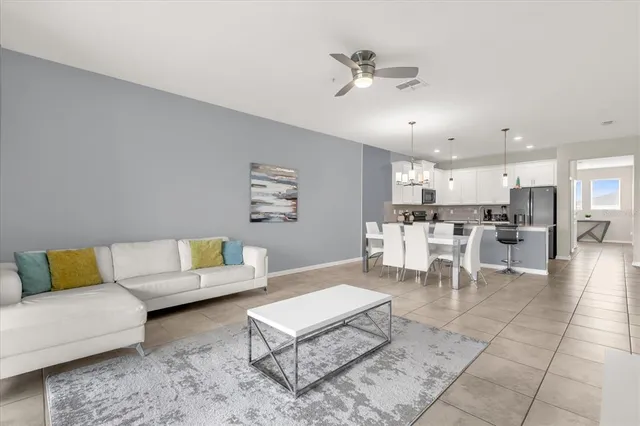 a living room with furniture and kitchen view