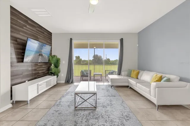 a living room with furniture and a large window