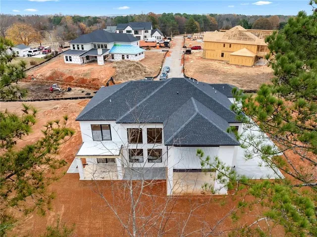an aerial view of a house with a yard and lake view