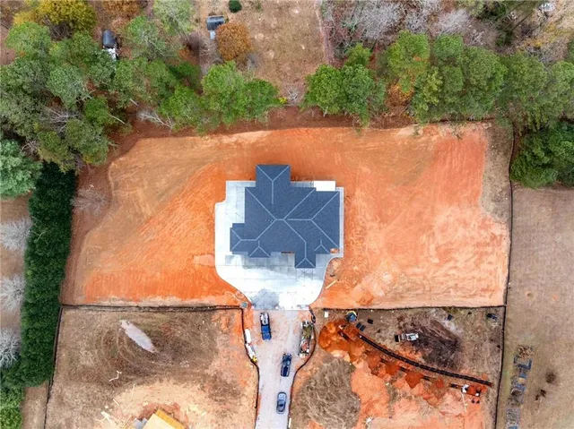 an aerial view of a house with a yard and lake view