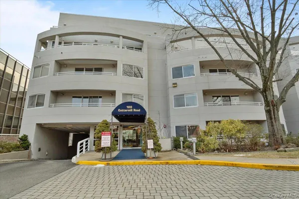 a view of a building with swimming pool and sitting area