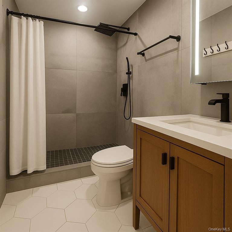 100 Cutter Mill Road, Unit 3E Great Neck, NY 11021 - Photo 11 of 14 a bathroom with a sink a toilet and shower