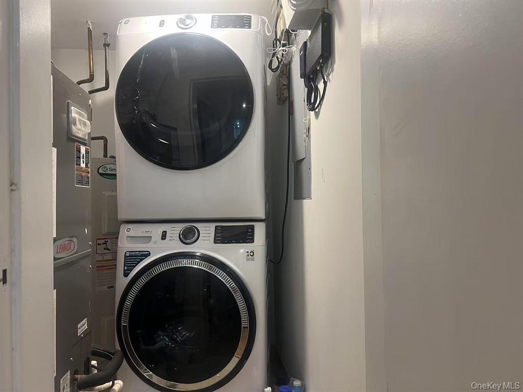 100 Cutter Mill Road, Unit 3E Great Neck, NY 11021 - Photo 14 of 14 a close view of a utility room with dryer and washer