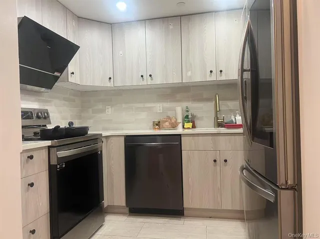 a kitchen with a refrigerator and cabinets