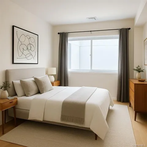 a bedroom with a large bed and a window