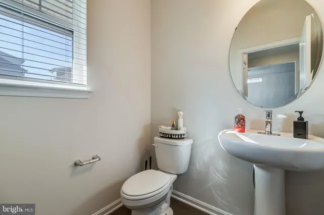 a bathroom with a toilet sink and mirror