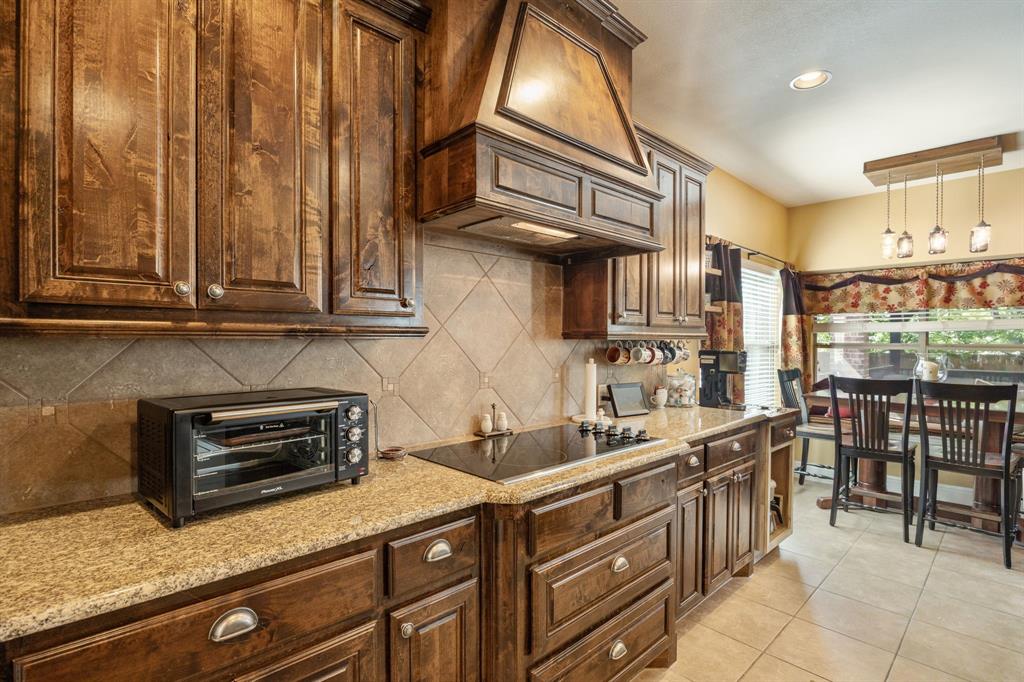 8104 Red Riv Run North Richland Hills, TX 76180 - Photo 9 of 38 a kitchen with stainless steel appliances granite countertop a sink and cabinets