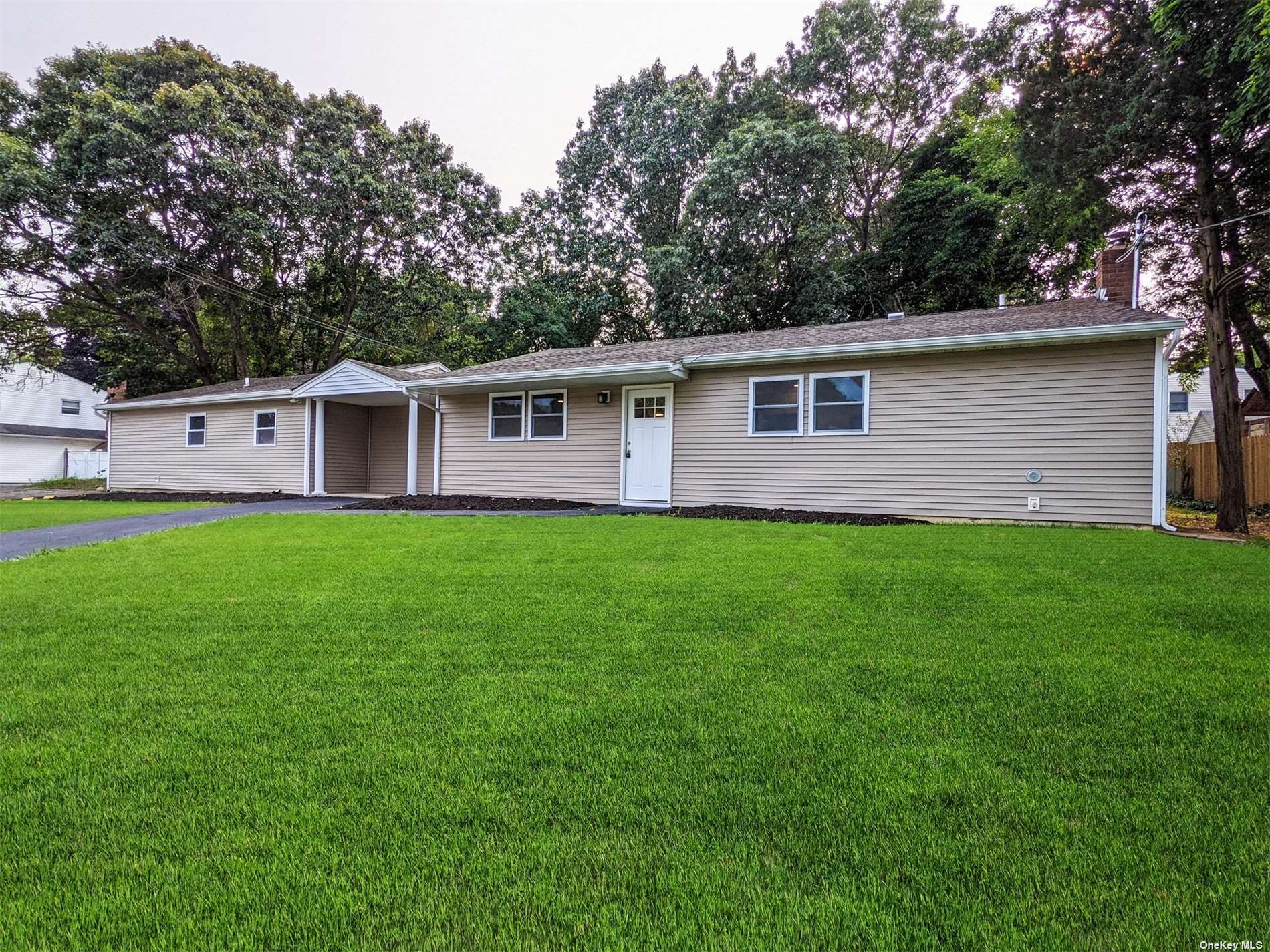 34 College Road Selden, NY 11784 - Photo 1 of 1 a front view of house with yard and green space