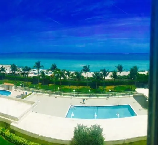 a view of a swimming pool with an outdoor space and seating area
