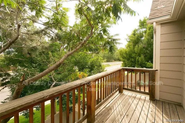 a view of balcony with wooden floor and fence