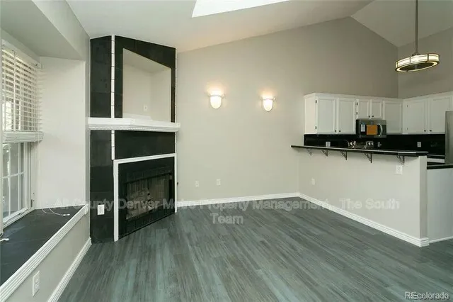 a view of a kitchen with wooden floor and cabinets