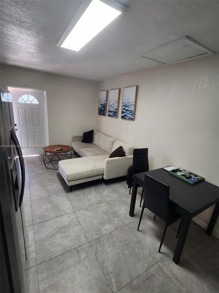 2165 Southwest 47th Street, Unit 2 Dania Beach, FL 33312 - Photo 4 of 10 a bedroom with a bed a desk and chair