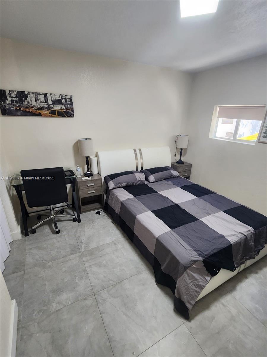 2165 Southwest 47th Street, Unit 2 Dania Beach, FL 33312 - Photo 6 of 10 a bedroom with a bed and a furniture