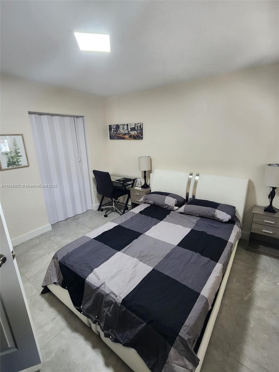 2165 Southwest 47th Street, Unit 2 Dania Beach, FL 33312 - Photo 7 of 10 a living room with a couch a rug and a window