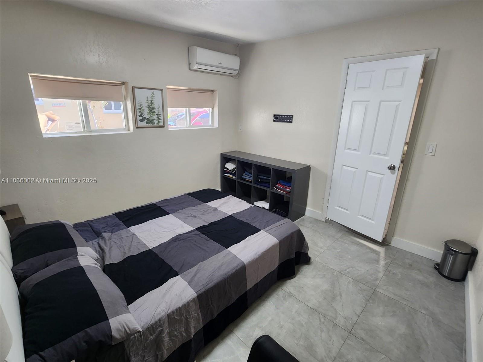 2165 Southwest 47th Street, Unit 2 Dania Beach, FL 33312 - Photo 9 of 10 a bedroom with a bed and a window
