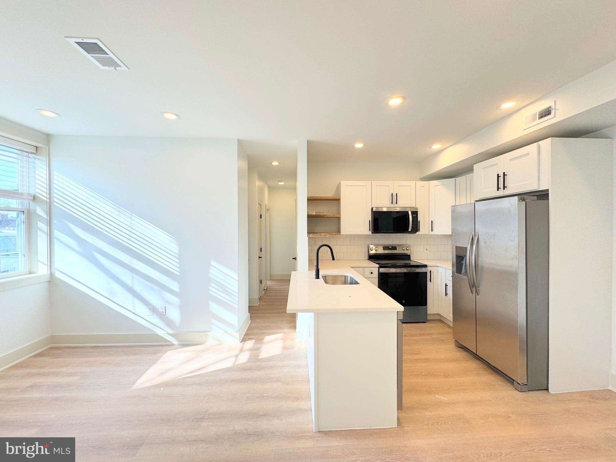 1802 11th Street Northwest, Unit 3B Washington, DC 20001 - Photo 13 of 19 a kitchen with stainless steel appliances a refrigerator and a stove top oven