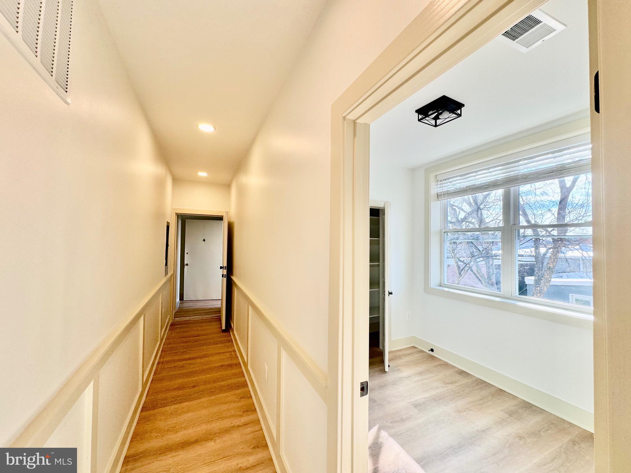 1802 11th Street Northwest, Unit 3B Washington, DC 20001 - Photo 15 of 19 a view of a hallway with wooden floor and windows