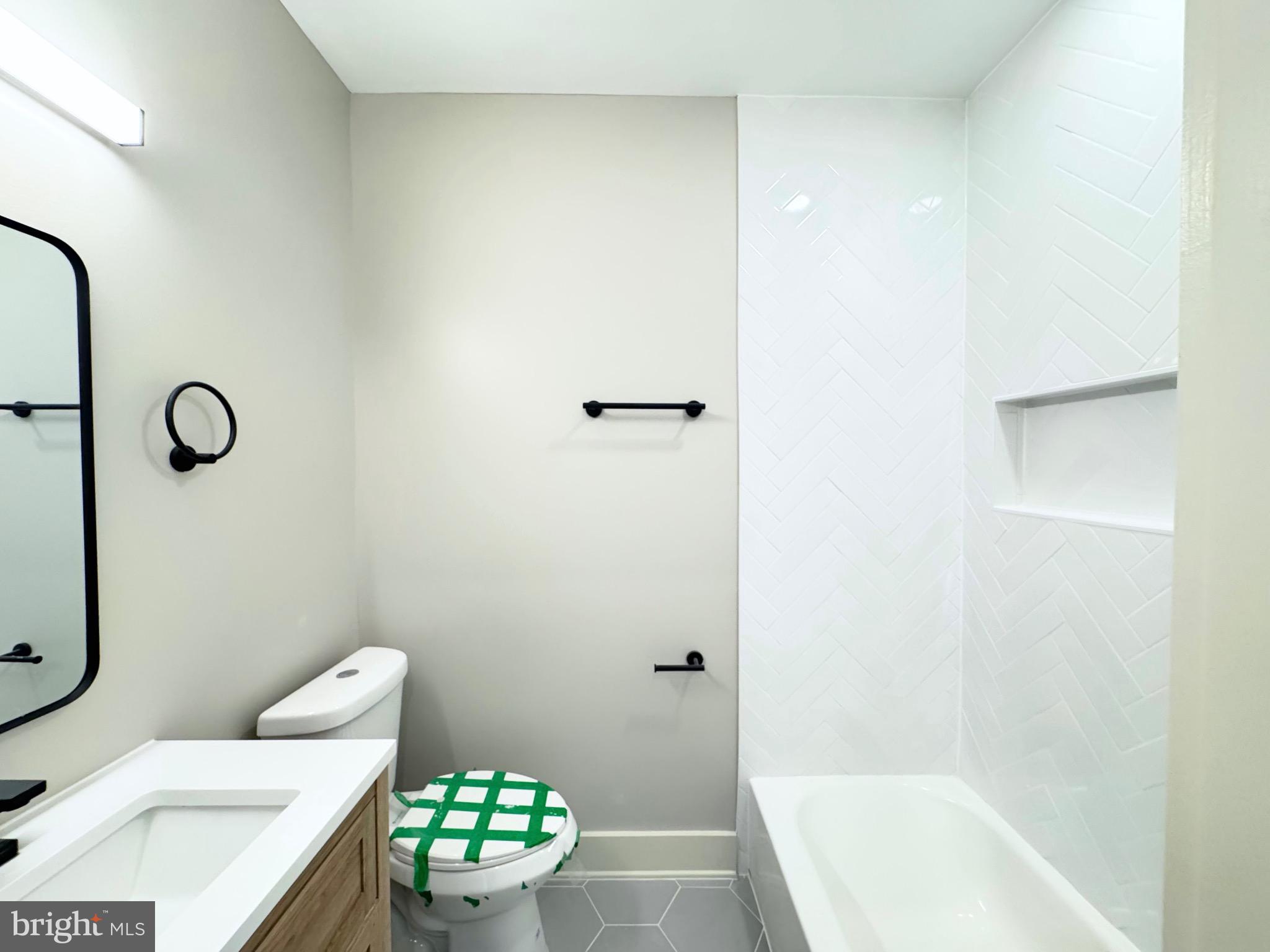 1802 11th Street Northwest, Unit 3B Washington, DC 20001 - Photo 16 of 19 a bathroom with a bathtub sink mirror and toilet