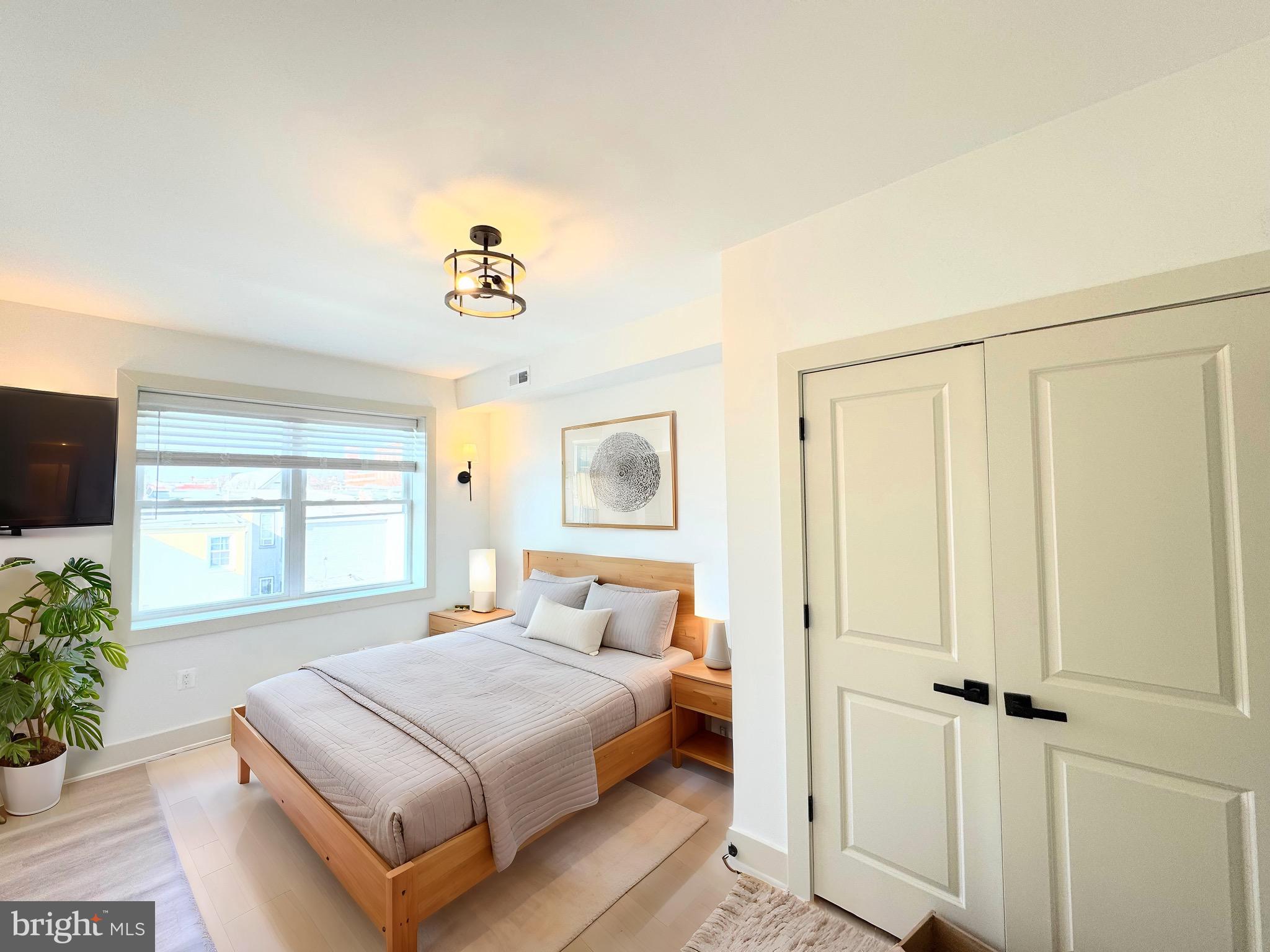 1802 11th Street Northwest, Unit 3B Washington, DC 20001 - Photo 4 of 19 a bedroom with a bed and a window