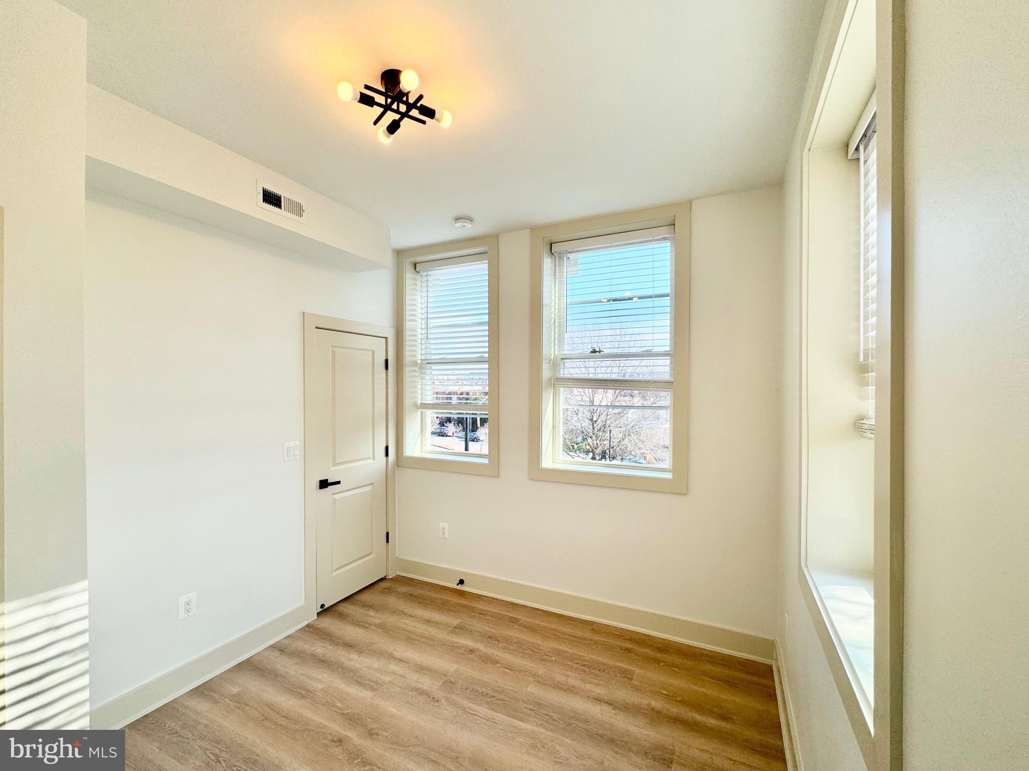 1802 11th Street Northwest, Unit 3B Washington, DC 20001 - Photo 10 of 19 a view of an empty room with wooden floor and a window