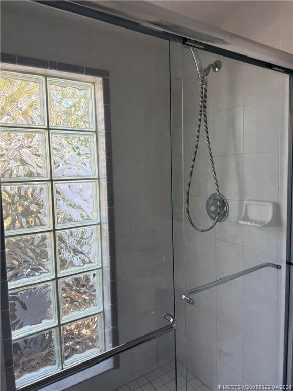 33 Southeast Sailfish Lane Stuart, FL 34996 - Photo 14 of 18 a bathroom with a glass shower door