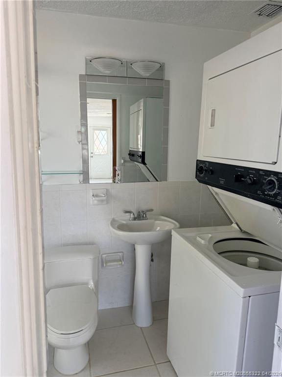 33 Southeast Sailfish Lane Stuart, FL 34996 - Photo 16 of 18 a bathroom with a toilet sink and mirror