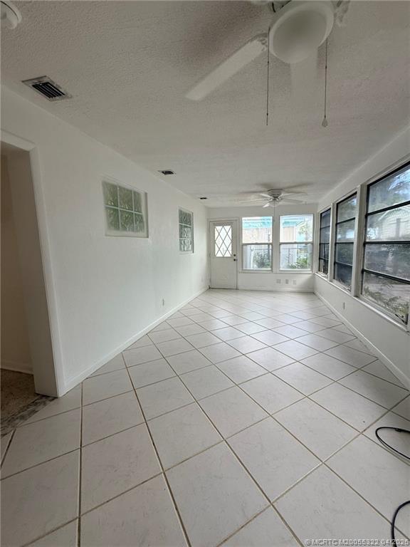33 Southeast Sailfish Lane Stuart, FL 34996 - Photo 17 of 18 a view of an empty room with glass door and windows