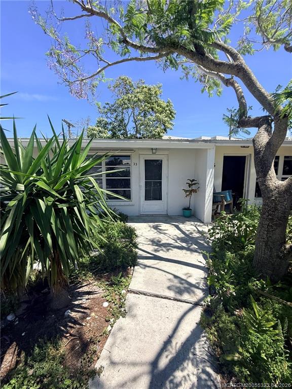 33 Southeast Sailfish Lane Stuart, FL 34996 - Photo 2 of 18 a front view of a house with a yard