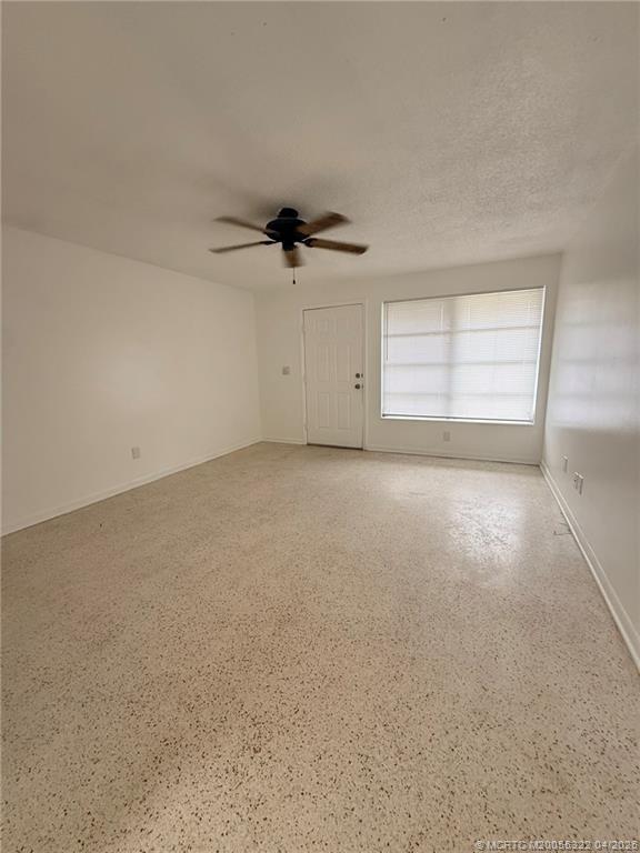 33 Southeast Sailfish Lane Stuart, FL 34996 - Photo 5 of 18 an empty room with a ceiling fan and window