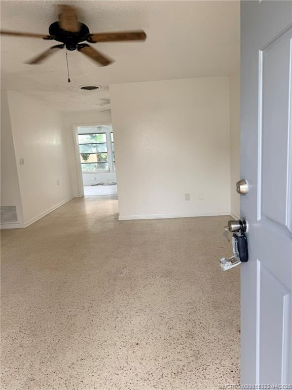 33 Southeast Sailfish Lane Stuart, FL 34996 - Photo 7 of 18 en empty room with windows and ceiling fan