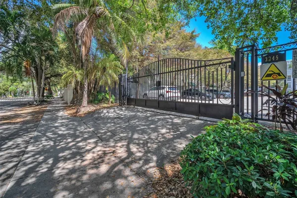 a view of a backyard with iron fence