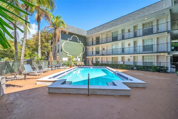 a swimming pool with outdoor seating and yard
