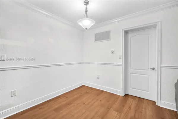 a view of a room with wooden floor