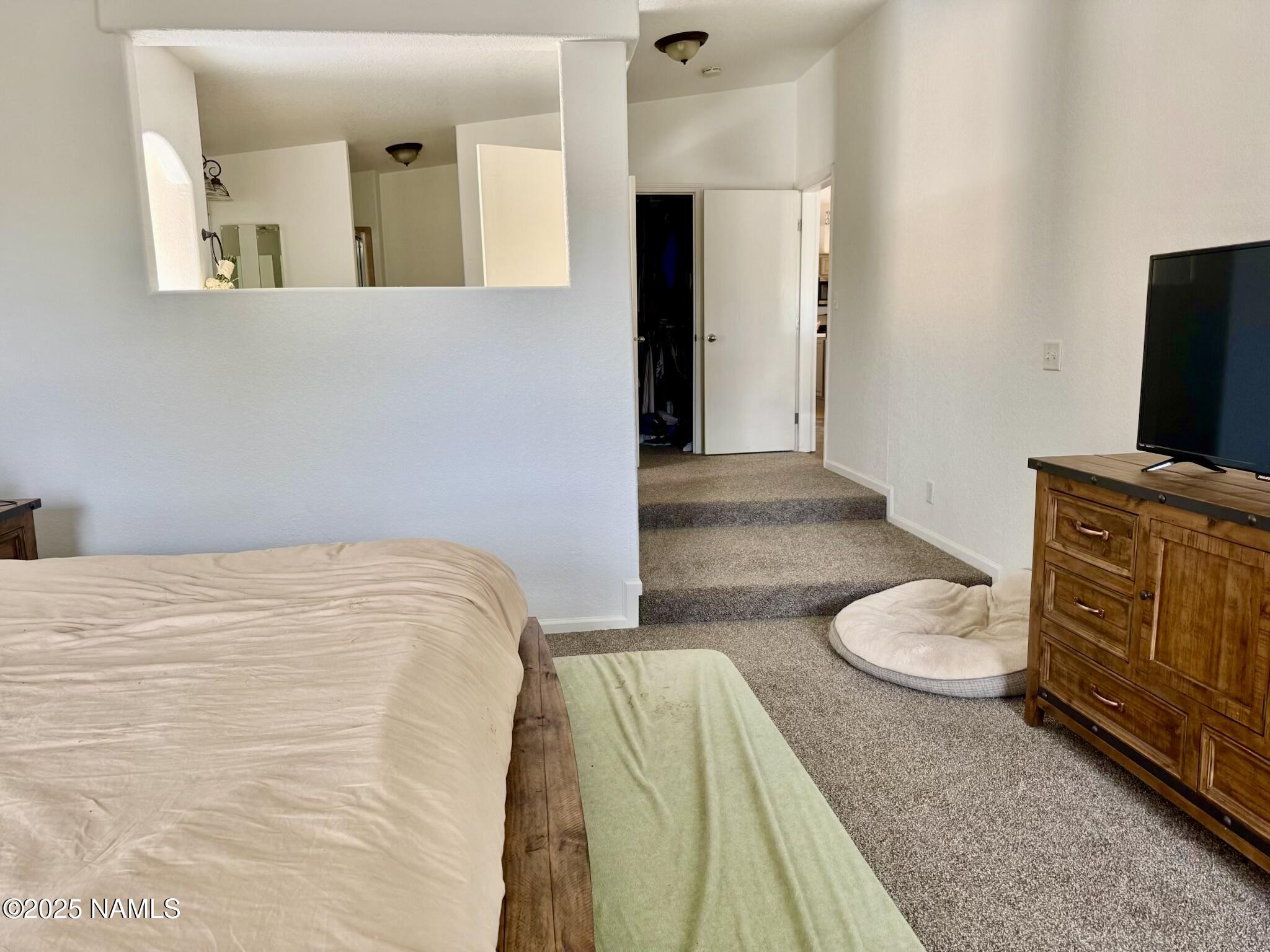 6083 North Joshua Tree Road Williams, AZ 86046 - Photo 15 of 40 a bedroom with a bed and a flat screen tv