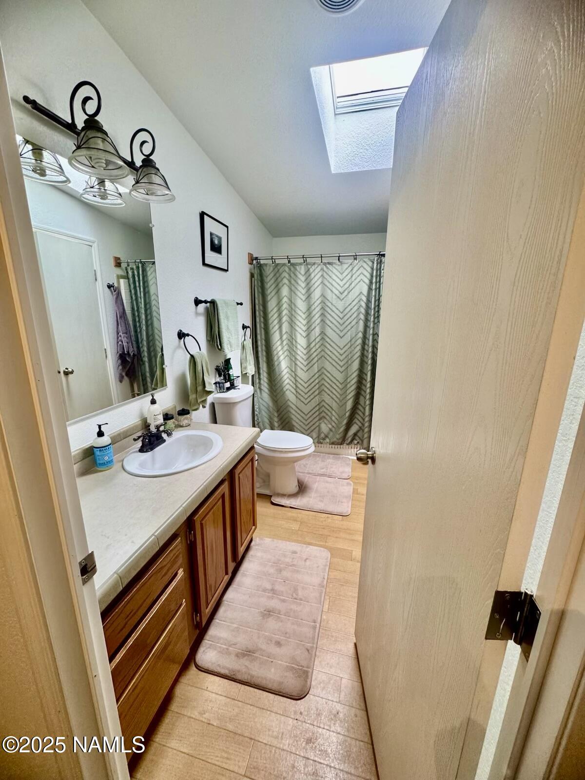 6083 North Joshua Tree Road Williams, AZ 86046 - Photo 19 of 40 a bathroom with a sink a toilet and mirror