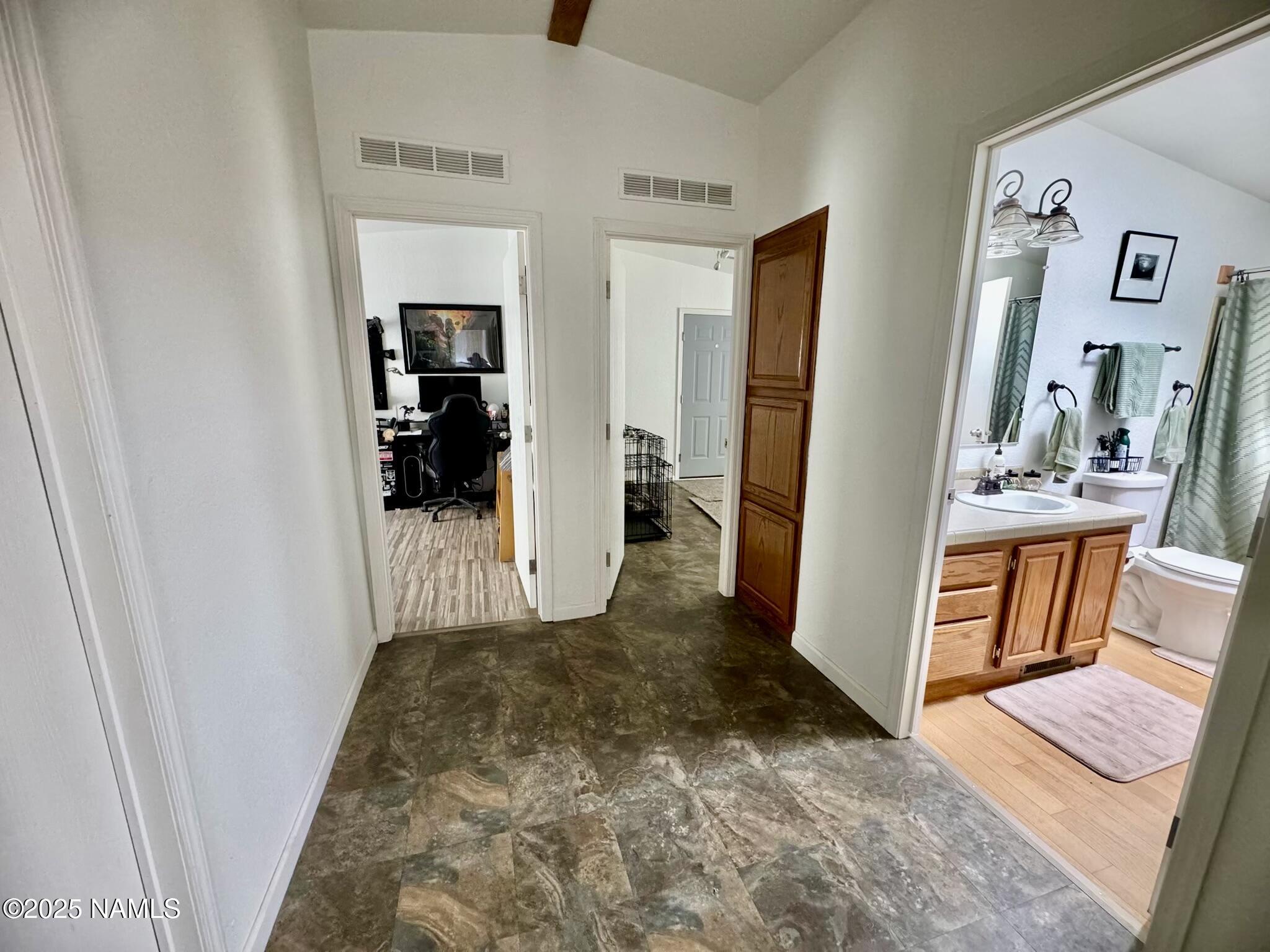 6083 North Joshua Tree Road Williams, AZ 86046 - Photo 20 of 40 a view of a bedroom with wooden floor and furniture