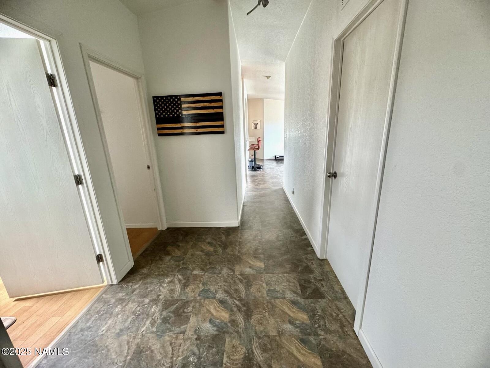 6083 North Joshua Tree Road Williams, AZ 86046 - Photo 21 of 40 a view of a hallway with wooden floor