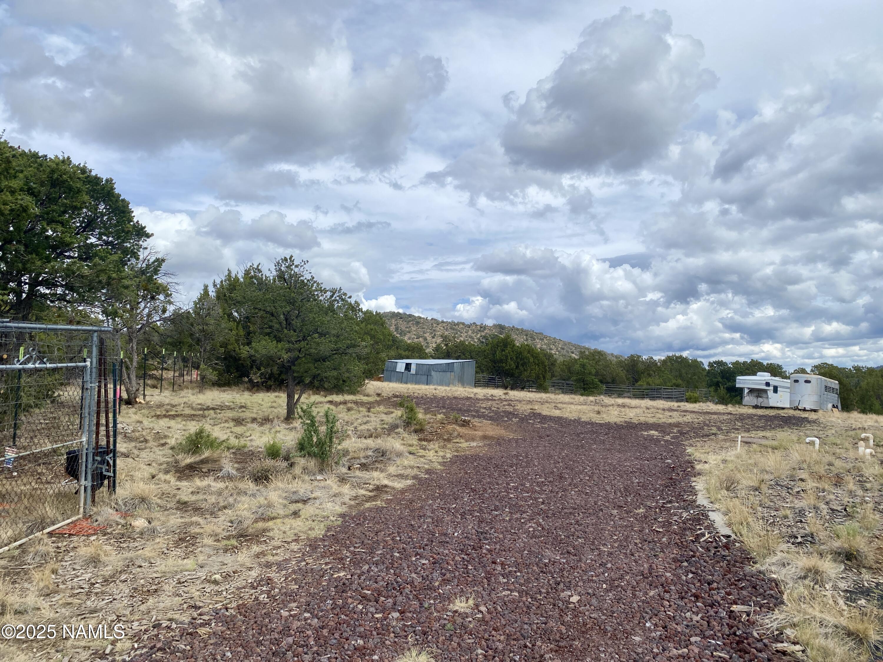 6083 North Joshua Tree Road Williams, AZ 86046 - Photo 30 of 40 a view of dirt yard with wooden fence