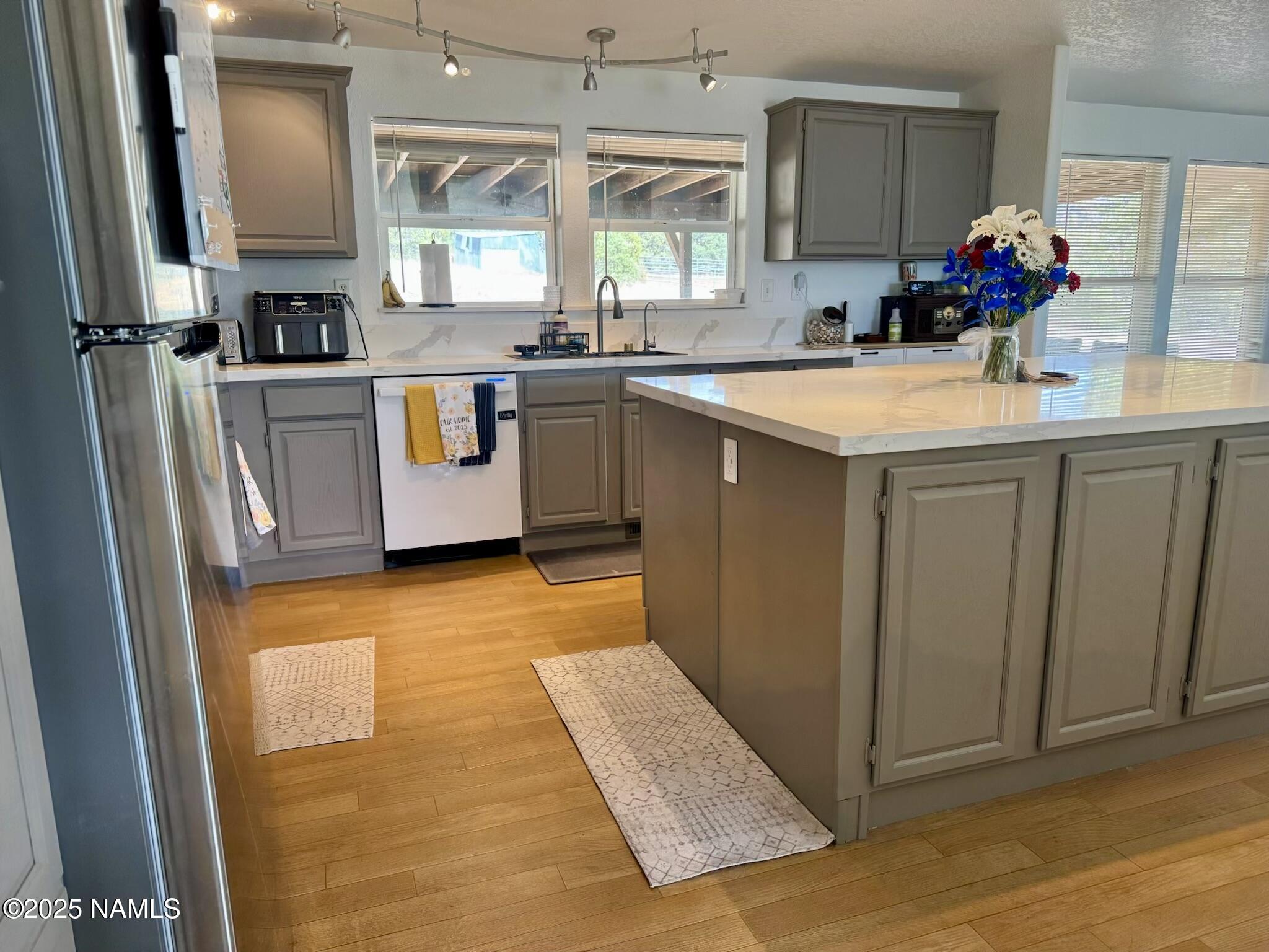 6083 North Joshua Tree Road Williams, AZ 86046 - Photo 5 of 40 a kitchen with stainless steel appliances a sink stove and cabinets
